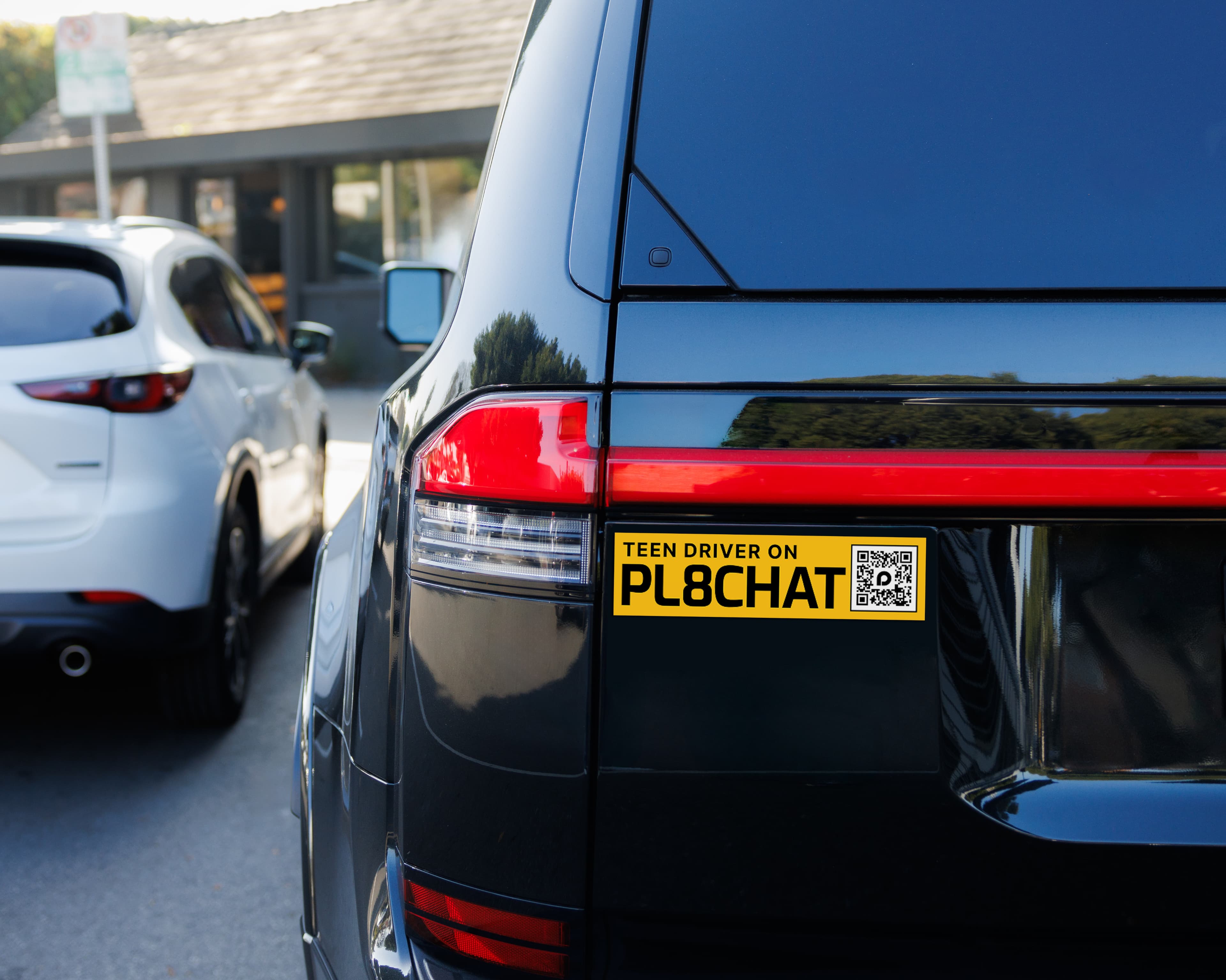 The rear of a PL8CHAT-connected fleet vehicle with illuminated lights.