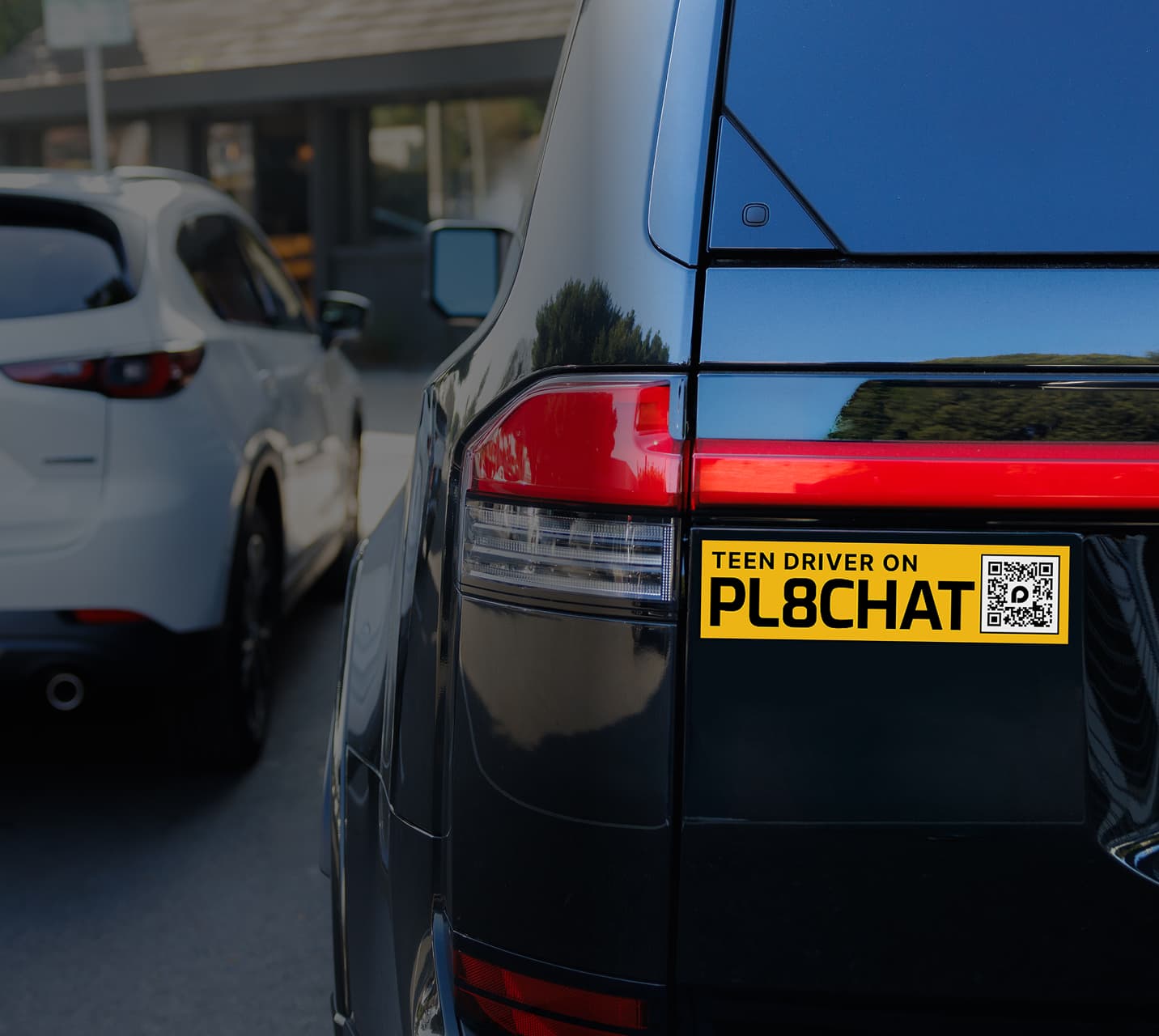 The rear of a PL8CHAT-connected fleet vehicle with illuminated lights.